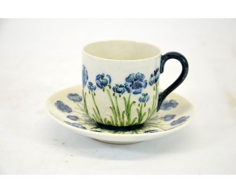 William Moorcroft for James Macintyre, poppy on white ground cup and saucer, circa 1910, signed, printed marks, height 7cm.