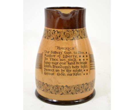 A Doulton Lambeth stoneware America pitcher, printed with a verse between two flags and floral scroll borders, 23cm high