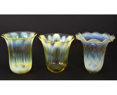 Three Arts and Crafts straw opal glass light shades, variously optic moulded stripe and wrythen patterns, one with crimped ri