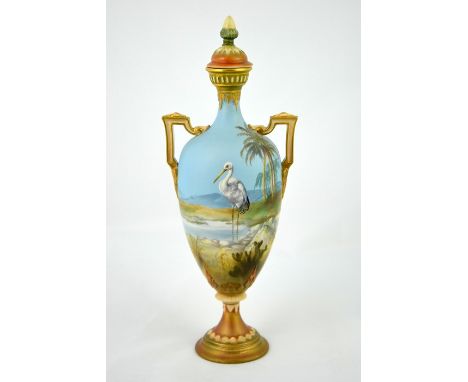 William Powell for Royal Worcester, a stork painted vase, 1909, pedestal amphora form, decorated with a bird in desert oasis,