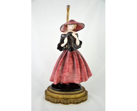 Claire Herczeg / Weiss for Goldscheider, a figural lamp base of a woman holding a mask, circa 1936, model 7691, figure 35cm h