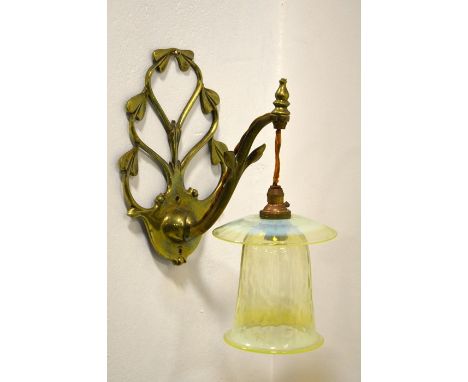 W A S Benson and James Powell and Sons,  an Arts and Crafts brass wall light, model 1312, with hanging straw opal glass shade