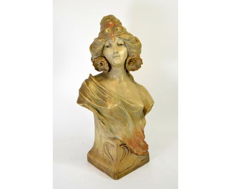 An Art Nouveau ceramic bust, modelled as a woman with poppies in her hair, draped in a shawl, signed indistinctly, Aug., 60cm