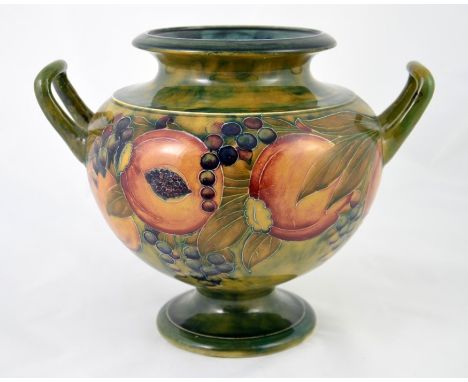 William Moorcroft, a Pomegranate vase,  pedastal amphora form with twin handles, circa 1910, signed, 28cm width 23cm high