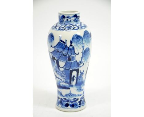 A Chinese blue and white vase, Kangxi mark and probably of the period, painted in the round with temple and garden scene with