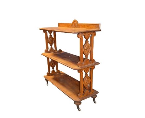 A Victorian oak buffet, circa 1860, three tiers, supported on incised open fret sides of oval roundels and Etruscan Acanthus 