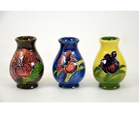 Walter Moorcroft, a group of three miniature vase's, baluster form, circa 1970, printed marks, height 5.5cm. (3)