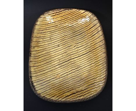 An 18th century Staffordshire combed slipware dish, shallow rectangular form with diagonal stripe and comb decoration, within