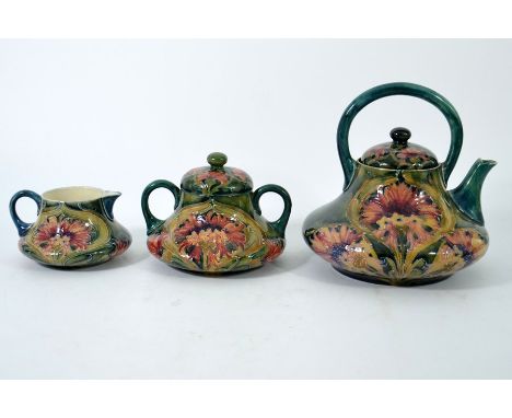 William Moorcroft, a Brown Chrysanthemum three piece tea set including tea-pot, milk and sugar bowl, squat baluster form with