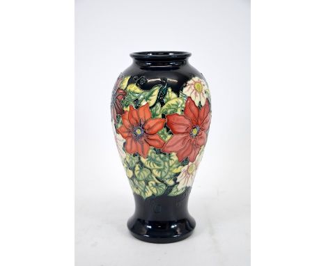 A Moorcroft Collectors Club 1998 vase, clematis pattern, black ground, baluster form, impressed marks, height 26cm