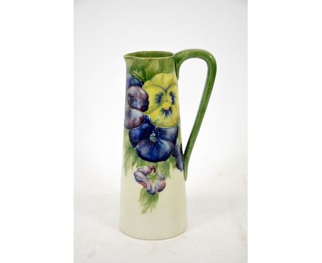 William Moorcroft, a pansy on white jug, slender form, circa 1914, signed, impressed marks, height 20cm,