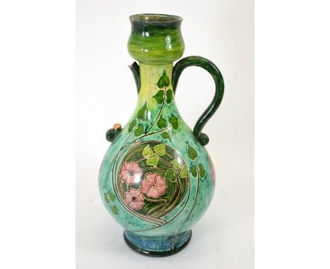 A large Della Robbia art pottery twin handled vase, gourd form, painted with roses and leaves within a spiral of tendrils, in