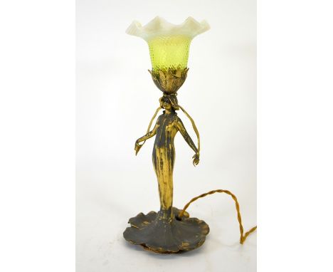 An Art Nouveau gilt metal figural table lamp, circa 1900, modelled as a woman holding a strand of grass, wearing a flowing dr