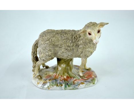 A Meissen figure of a sheep, circa 1880, modelled standing over a tree trunk, incised marks 1878, 9.5cm high