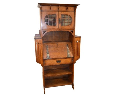 A Glasgow School, Arts and Crafts oak bureau, in the style of Wylie and Lochhead, the fall front with repousse  copper hinges