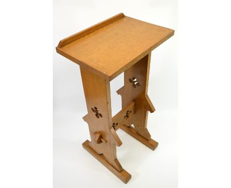 A Gothic Revival oak book stand, in the Pugin style, pegged construction with pierced quatrefoil decoration and shelf below, 