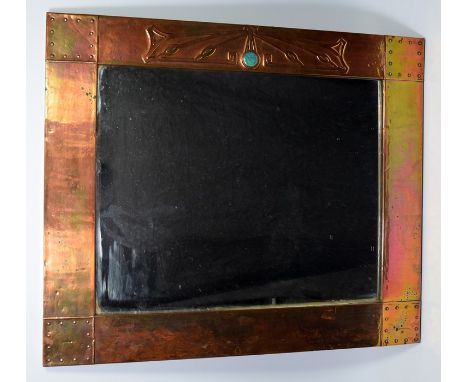 An Arts and Crafts Liberty-style copper framed rectangular mirror, with decorative rivets, set with a turquoise ceramic round