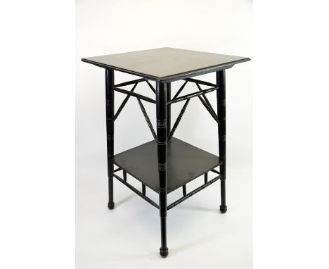 An Aesthetic Movement ebonised occasional table, in the style of E W Godwin, circa 1880, two tiers with turned and angled spi