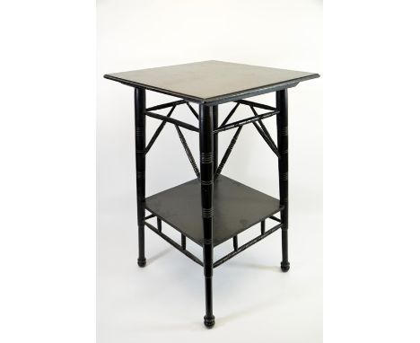 An Aesthetic Movement ebonised occasional table, in the style of E W Godwin, circa 1880, two tiers with turned and angled spi