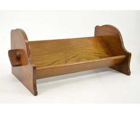 An Arts and Crafts peg jointed oak book trough, 43cm wide