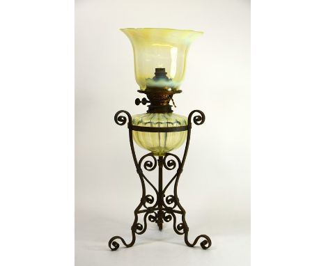 James Powell and Sons, an Arts and Crafts opalescent glass and wrought iron table oil lamp, circa 1885, the optic moulded str