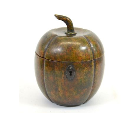 A George III fruitwood melon form tea caddy, with white metal escutcheon, lobed ovoid form with stem finial, green patina, 14