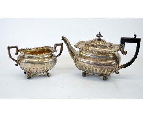 A Victorian silver two part tea set, squat baluster form with fluting and gadrooning, ebony handle and finial, Elkington and 