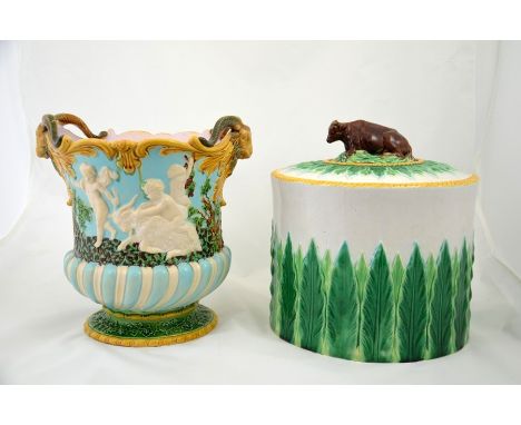 A George Jones majolica cheese dome and a Minton majolica rams head wine cooler, modelled in relief with Bacchanalian revelle