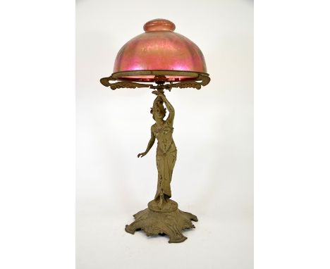 An Art Nouveau figural table lamp with Loetz type iridescent glass dome shade, circa 1900, papillon effect green and pink lus