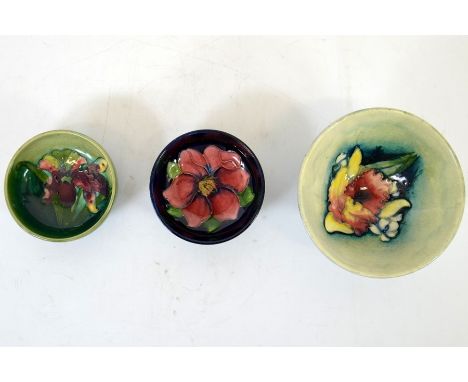 A group of three Moorcroft bowls, a clematis, a frilled orchid and an orchid, signed and impressed marks, widest diameter 11c