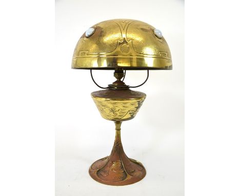 Georges Leleu, an Art Nouveau brass table lamp, the base cast with water lilies in lake with rush, the reservoir similarly de