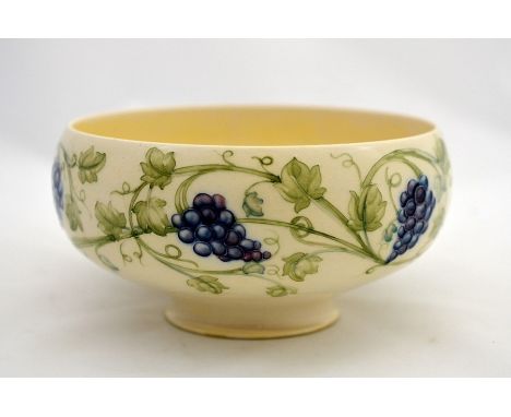William Moorcroft for Liberty and Co., a Grapes bowl, circa 1906, ovoid form, on cream ground, the underisde with yellow lust