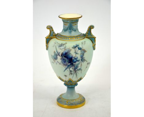 A Royal Worcester blue ivory vase, circa 1900, twin handled pedestal form with relief moulded swags and lappets, painted with