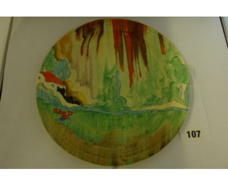 A Clarice Cliff Forest Glen plate, measuring 9¾ inches, hand painted with a stylised tree and cottage with tonal red and brow