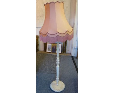 A white painted standard lamp with pink shade