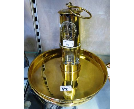 A brass safety lamp by Eccles, type 6, 23cm high together with two brass circular trays