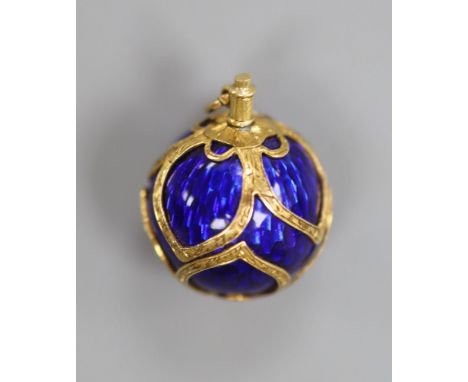 A 19th century engraved yellow metal and blue enamel set sphere pendant, 16mm, gross 7.7 grams.CONDITION: There are a couple 