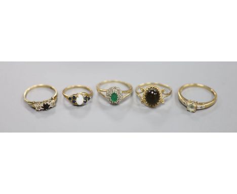 Five assorted modern 9ct gold and gem set rings, including emerald and diamond chip and white opal and sapphire, gross weight