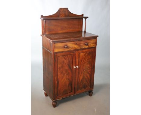 A small Regency mahogany chiffonier, with single shelf raised back, frieze drawer and two panelled doors on turned feet, W.72