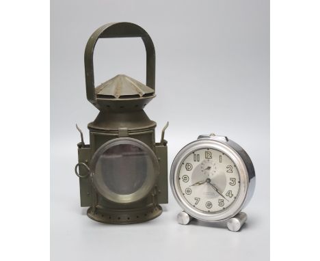 A green painted railway lantern, 30cm high, together with a French chrome cased alarm clock, the silvered dial marked Ch.Daus