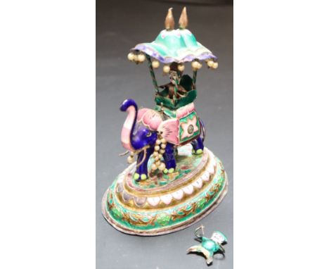 An Indian enamelled white metal miniature elephant with howdah, height 13.7cm, gross 295 grams.CONDITION: Damage/loss to the 