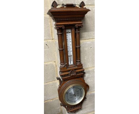 An Edwardian carved oak aneroid barometer and thermometer, height 80cm