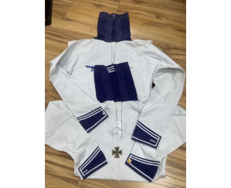 Two German Third Reich period white naval tunics, one named 'Schmidt. R, X176 T', together with an associated 1939 iron cross