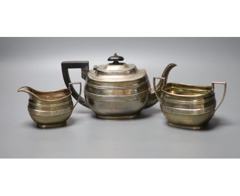 A George V reeded silver oval three piece tea set, George Howson, London, 1910, gross 16oz.