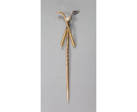 An early 20th century yellow metal and seed pearl set 'crossed golf clubs' stick pin, 57mm, gross 1.6 grams.