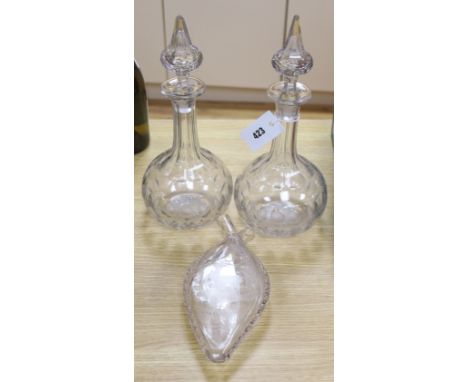 A pair of panel cut clear glass decanters , 36cm high and a wheel engraved glass flask, dated 1886, 24cm high (3)