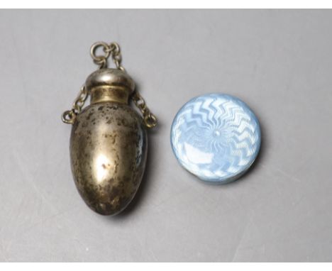 A late Victorian silver egg shaped scent bottle, Birmingham, 1900, 51mm and a 1920's silver and enamel pill box.CONDITION: Sc