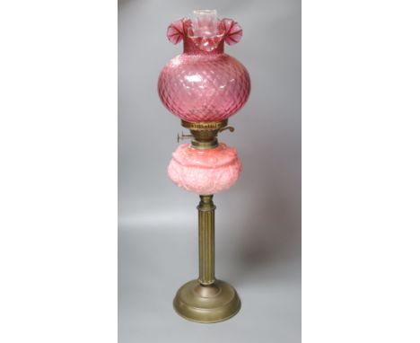 A Victorian brass and pink glass oil lamp, height 70cm