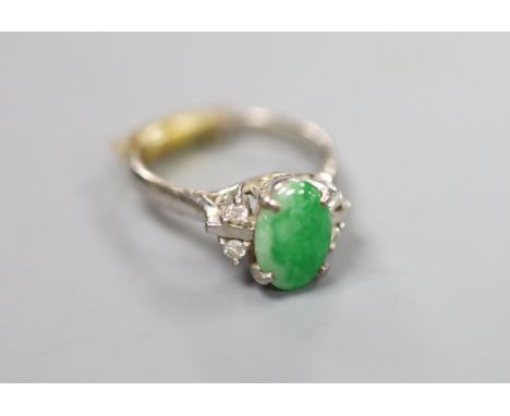 A 20th century 585 white metal, cabochon jade and diamond set five stone ring, size H/I, gross 3.6 grams.