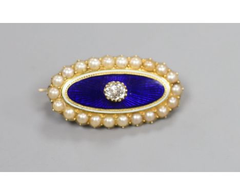 A Victorian yellow metal, blue enamel, seed pearl and diamond set oval brooch, 29mm, gross 6.8 grams, with glazed panel en ve